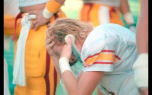 A frustrated Todd Marinovich talks with his offensive coordinator in the “All I Saw Was Purple” game at Husky Stadium in 1990.